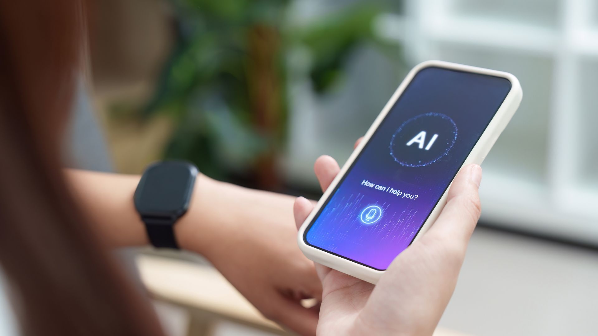 Una persona tiene in mano uno smartphone con un assistente AI aperto sullo schermo e la domanda «How can i help you?»